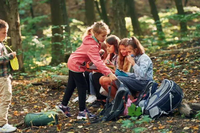 Kids in green forest at summer daytime together Kids in green forest at summer daytime together